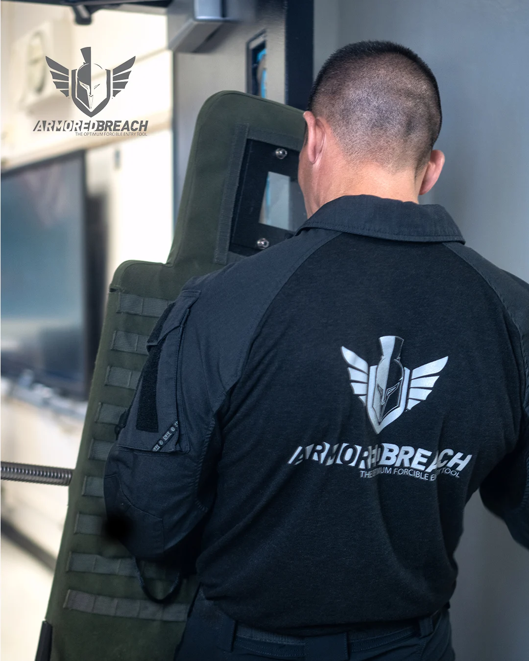 Rear view of an operator carrying the Guardian Breaching Shield